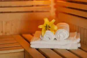 Sauna with towels and a flower